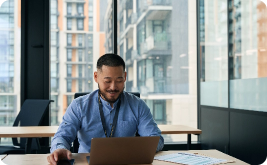 Man working on laptop in an office building